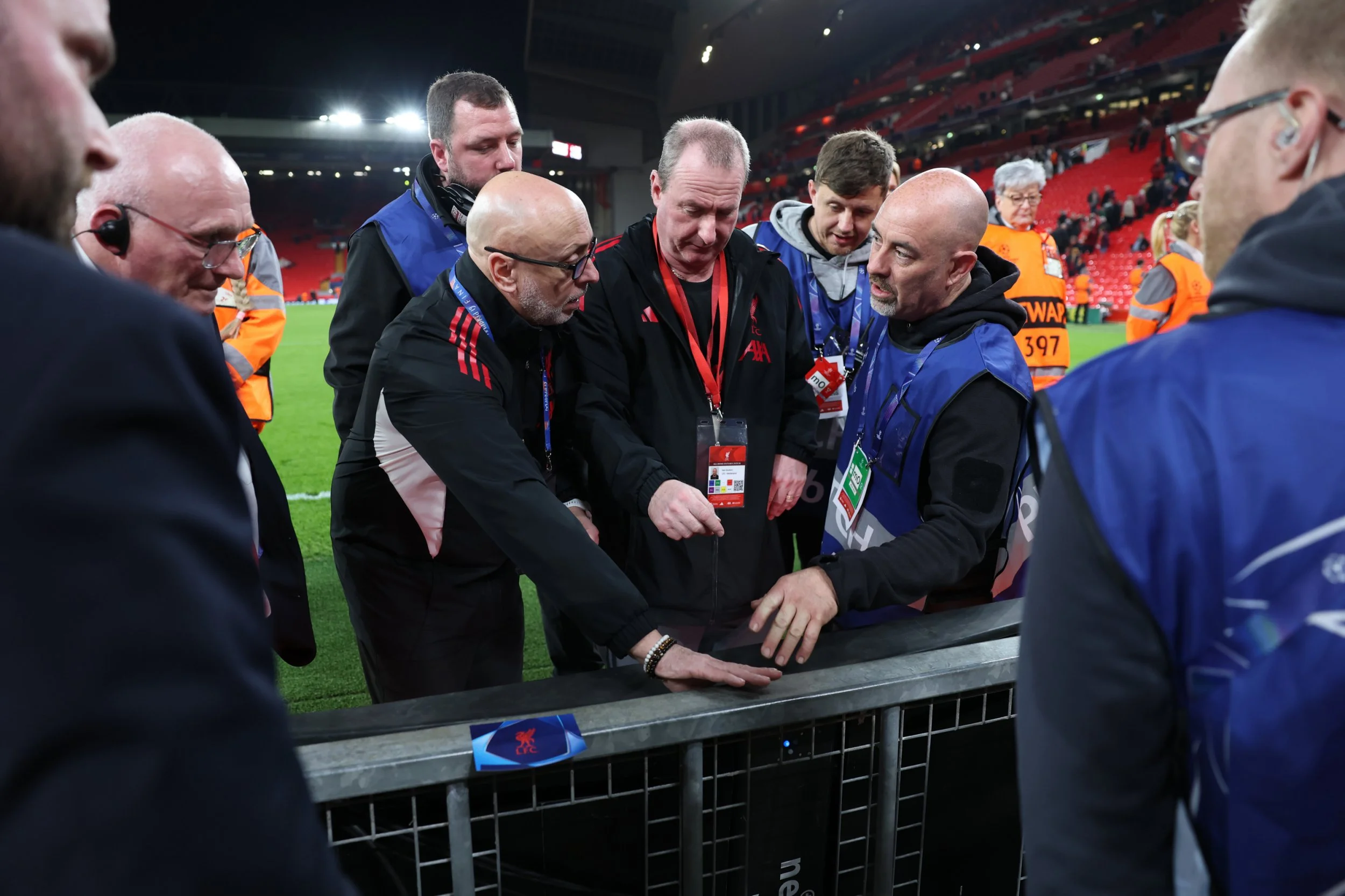 LIVERPOOL, ENGLAND - MARCH 18: Ground staff and members of Liverpool investigate the board on which Noa Lang of Galatasaray A.S. (not pictured) sustained an injury to his thumb during the UEFA Champions League 2025/26 Round of 16 Second Leg match between Liverpool FC and Galatasaray SK at Anfield on March 18, 2026 in Liverpool, England. (Photo by Carl Recine/Getty Images)