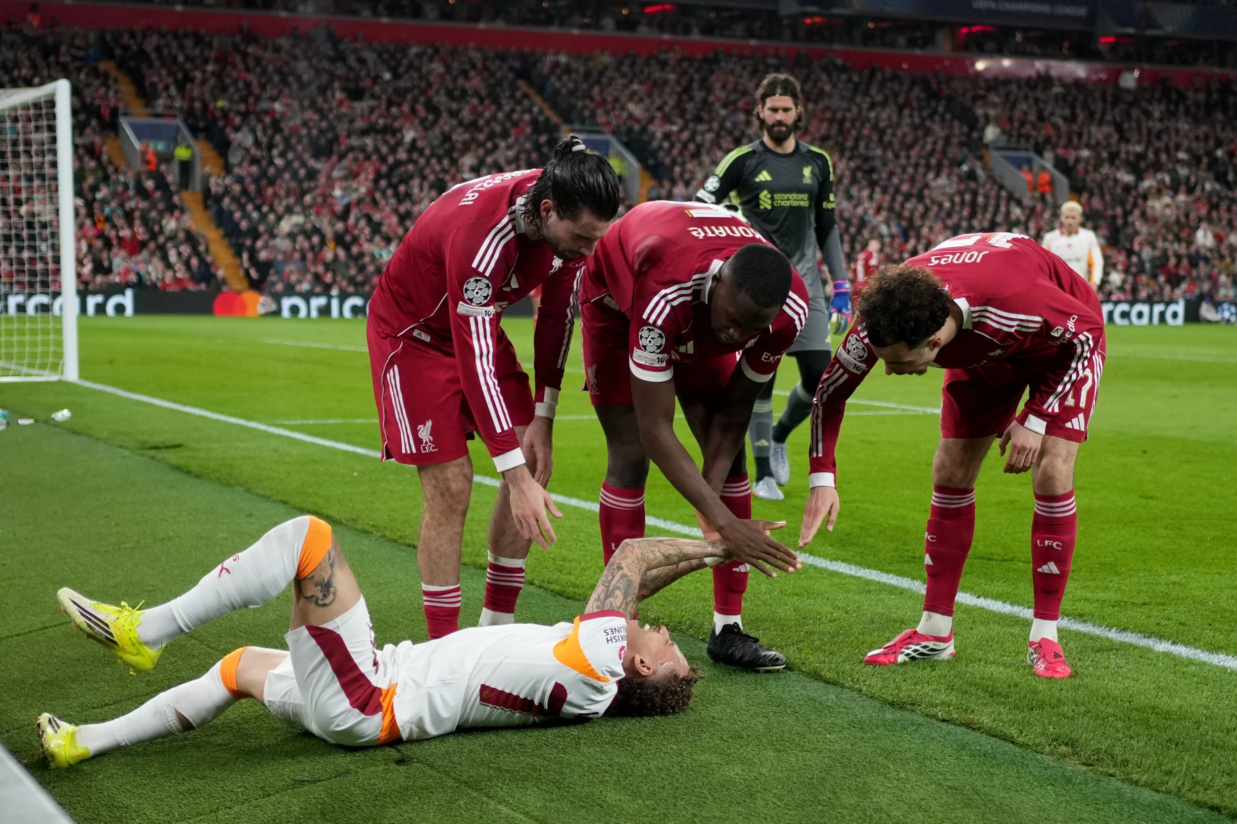 Galatasaray's Noa Lang reacts after sustaining an injury during the second leg of the Champions League round of 16 soccer match between Liverpool and Galatasaray, in Liverpool, England, Wednesday, March 18, 2026. (AP Photo/Jon Super)